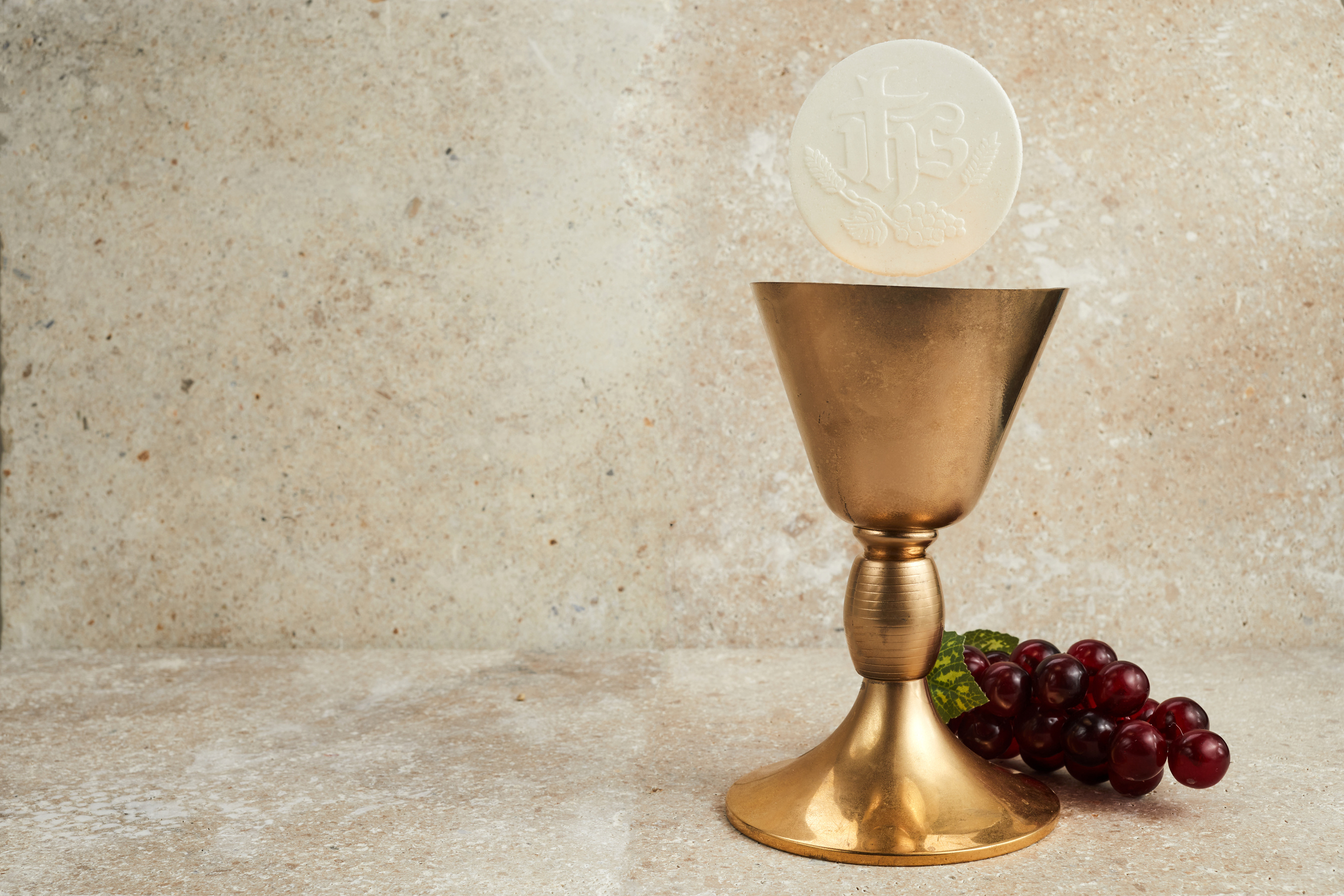 Christian Holy Communion with Chalice on Stone Background